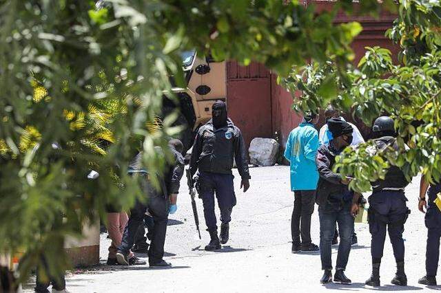 Members of the Haitian police and forensics look for evidence outside of the presidential residence on July 7, 2021 in Port-au-Prince, Haiti. - Haiti President Jovenel Moise was assassinated and his wife wounded early July 7, 2021 in an attack at their home, the interim prime minister announced, an act that risks further destabilizing the Caribbean nation beset by gang violence and political volatility. Claude Joseph said he was now in charge of the country and urged the public to remain calm, while insisting the police and army would ensure the population's safety.The capital Port-au-prince as quiet on Wednesday morning with no extra security forces on patrol, witnesses reported. (Photo by VALERIE BAERISWYL / AFP) (Photo by VALERIE BAERISWYL/AFP via Getty Images)